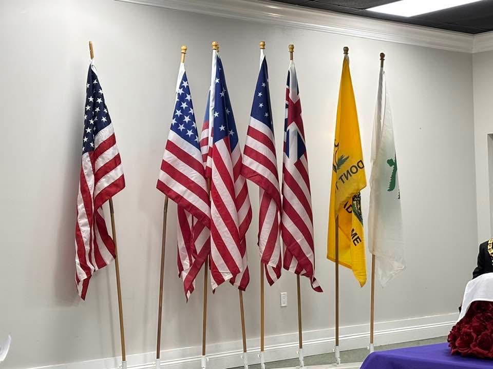 Historic United States flags displayed during the Bristol Elks Flag Day ceremony
